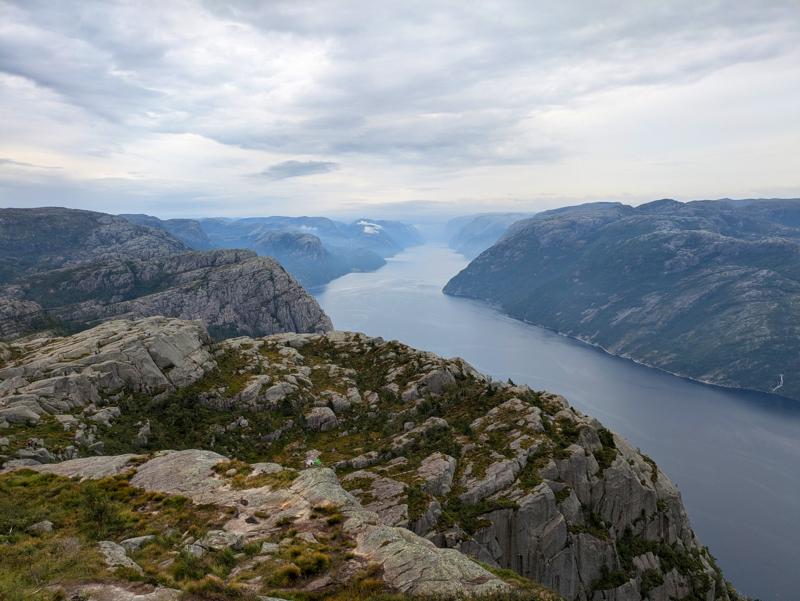 This photo shows a fjord and mountains.